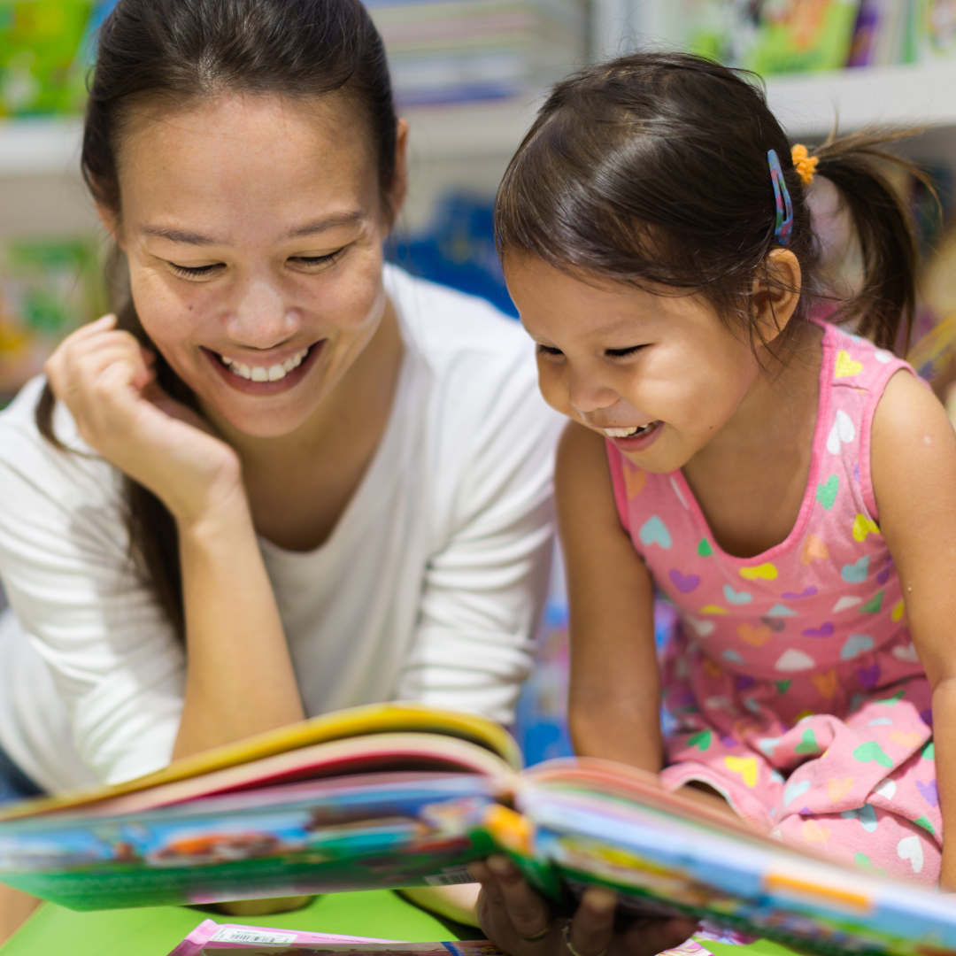 parent reading a picture book with young child